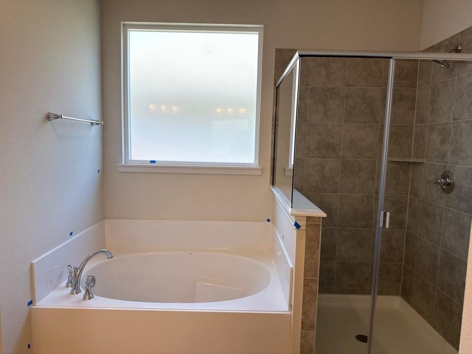 1325 Frio Drive Springtown, TX 76082 - Photo 8 of 10 a white bath tub sitting next to a shower