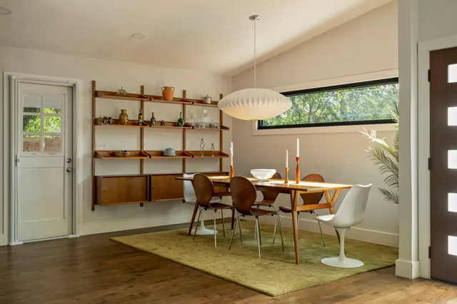 a view of a dining room with furniture and a window