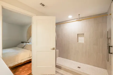 a bathroom with a bathtub and a shower