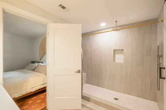 a bathroom with a bathtub and a shower