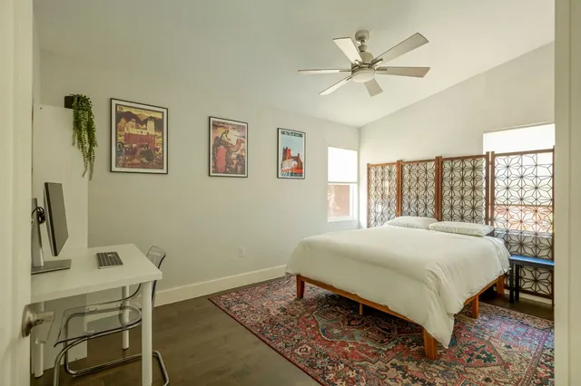 a bedroom with a bed and a table