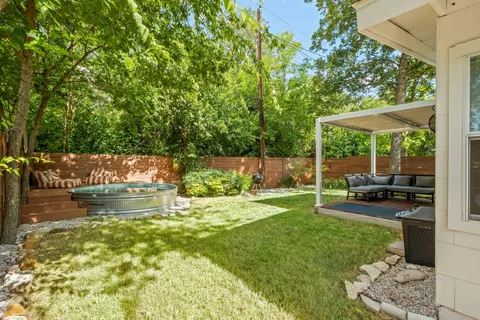 a view of yard with green space and seating area