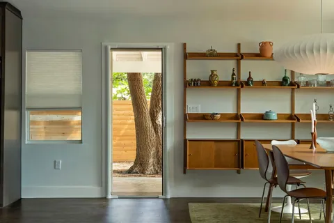 a dining room with furniture and window