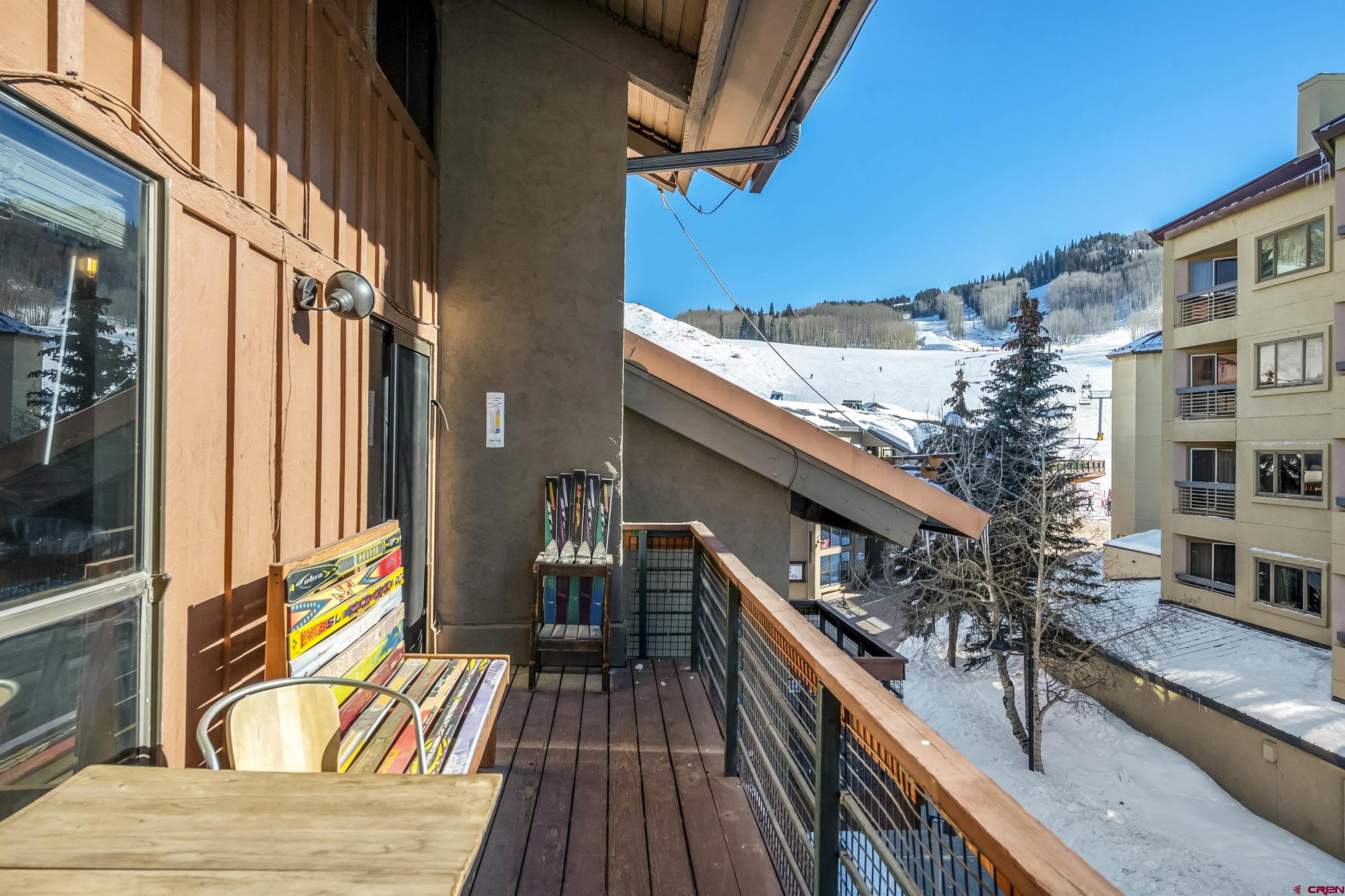 11 Emmons Road, Unit 430 Crested Butte, CO 81225 - Photo 12 of 27 a view of balcony with two chairs and wooden floor