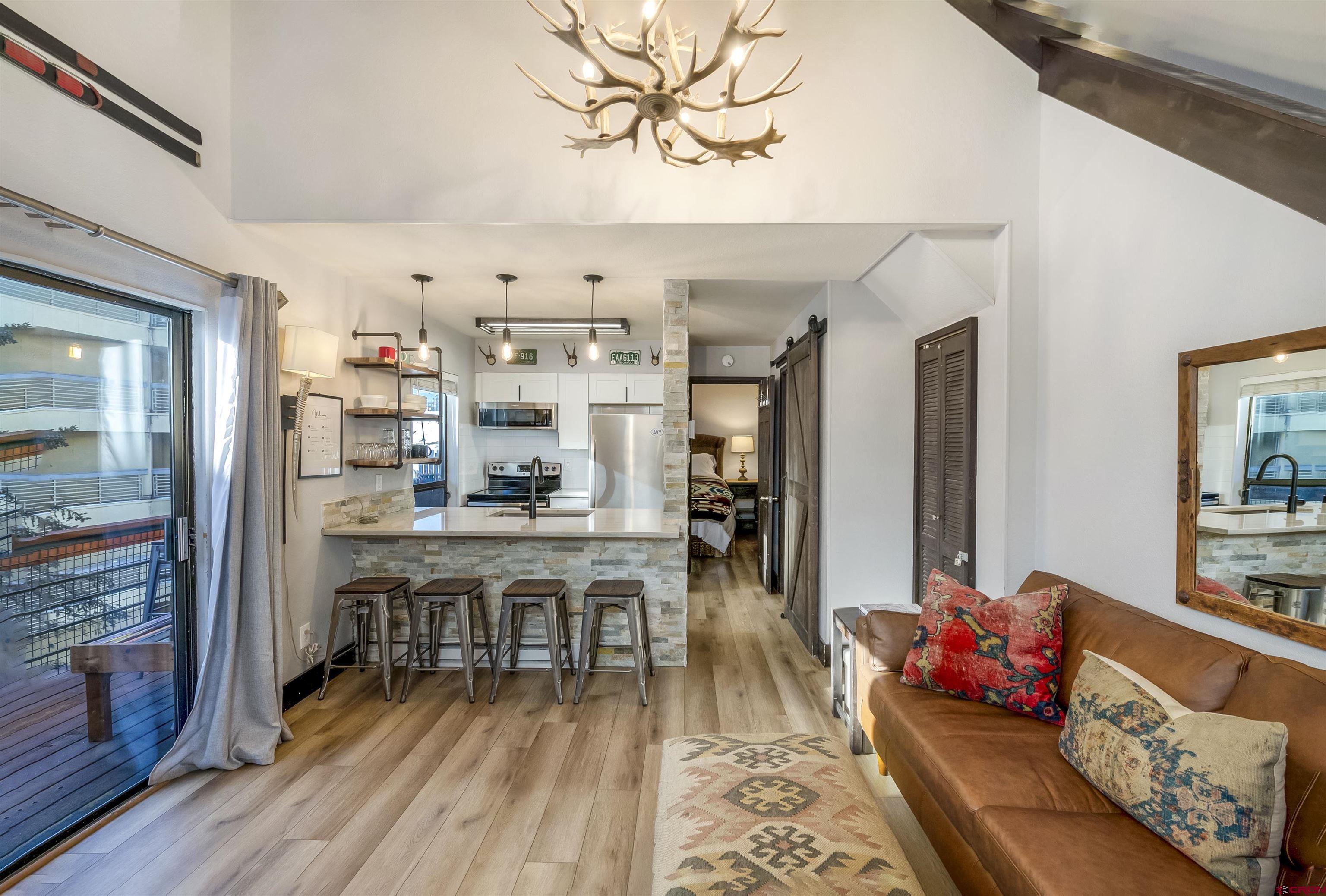 11 Emmons Road, Unit 430 Crested Butte, CO 81225 - Photo 4 of 27 a living room with furniture and wooden floor