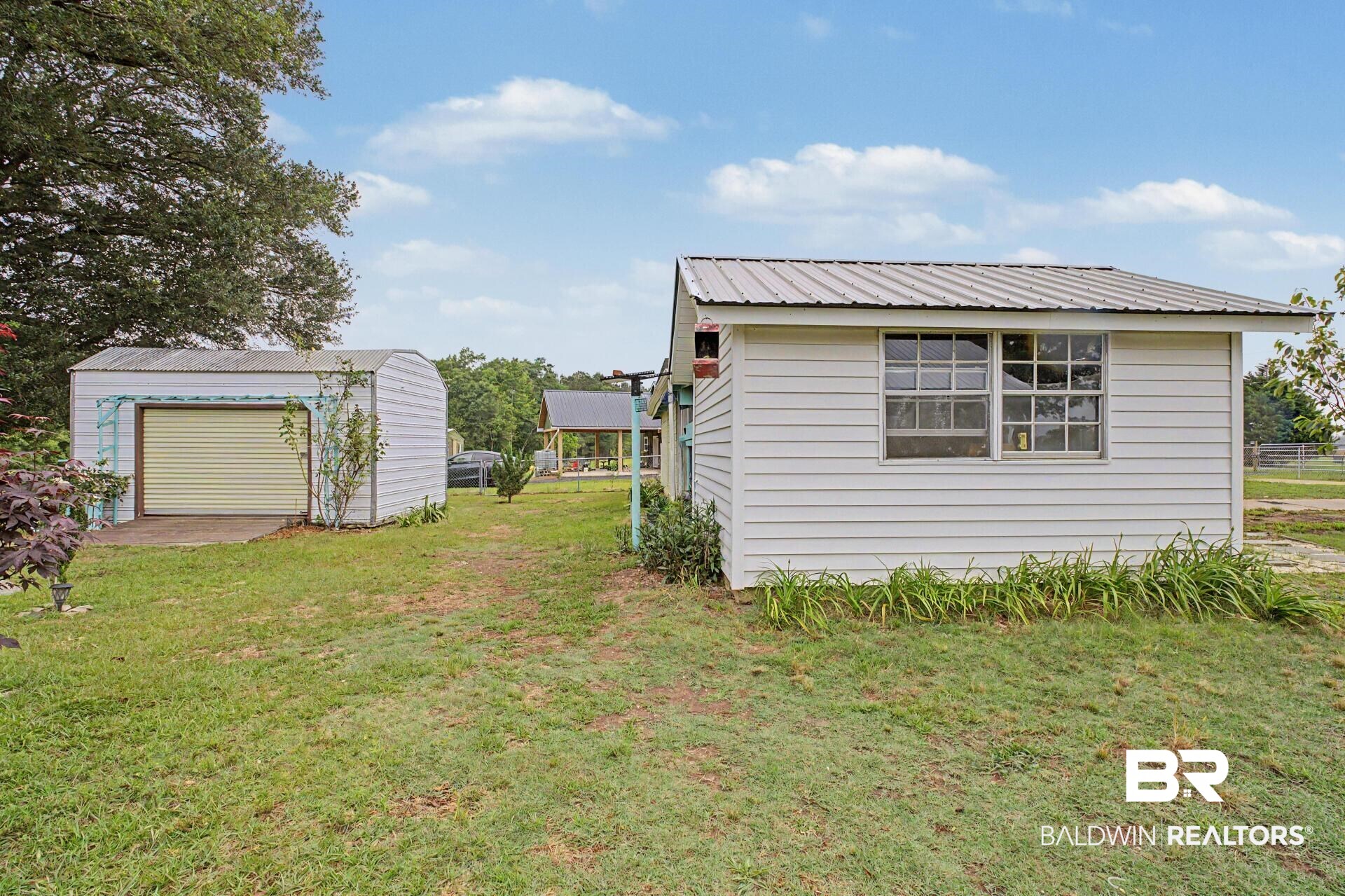 3791 Robinsonville Road Atmore, AL 36502 - Photo 15 of 47 Detached utility building with horizontal siding and a metal roof