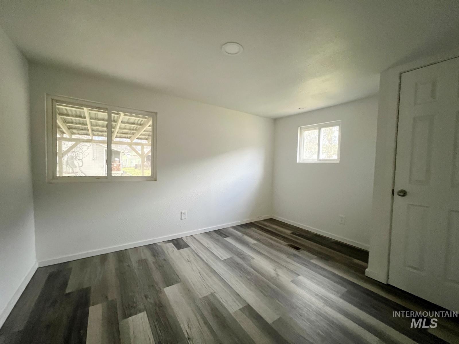 614 Pine Avenue Kooskia, ID 83539 - Photo 13 of 27 Unfurnished bedroom featuring dark wood-style flooring and baseboards