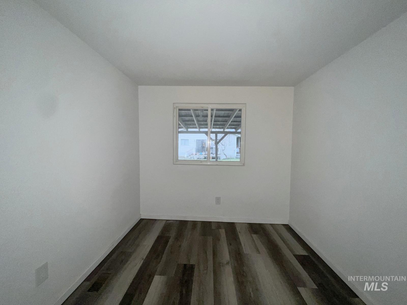 614 Pine Avenue Kooskia, ID 83539 - Photo 16 of 27 Empty room featuring dark wood-style floors and baseboards