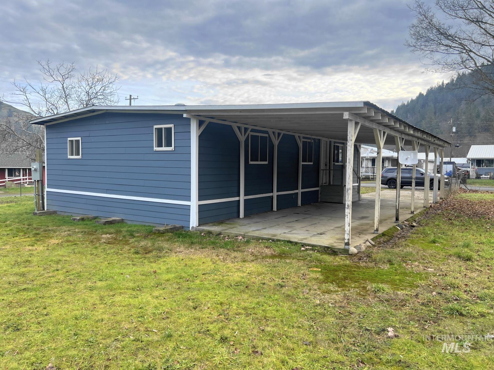614 Pine Avenue Kooskia, ID 83539 - Photo 22 of 27 Rear view of house featuring a carport and a yard