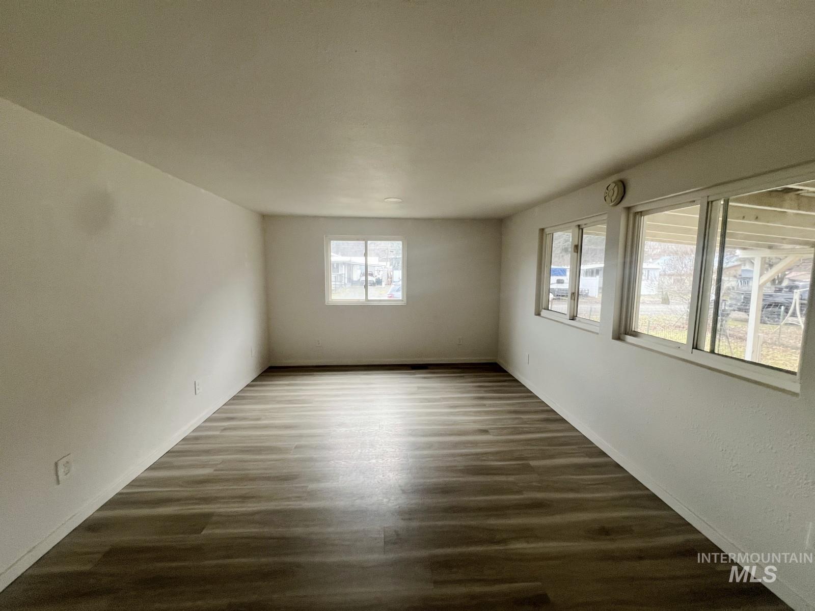614 Pine Avenue Kooskia, ID 83539 - Photo 4 of 27 Empty room with dark wood-style flooring and baseboards