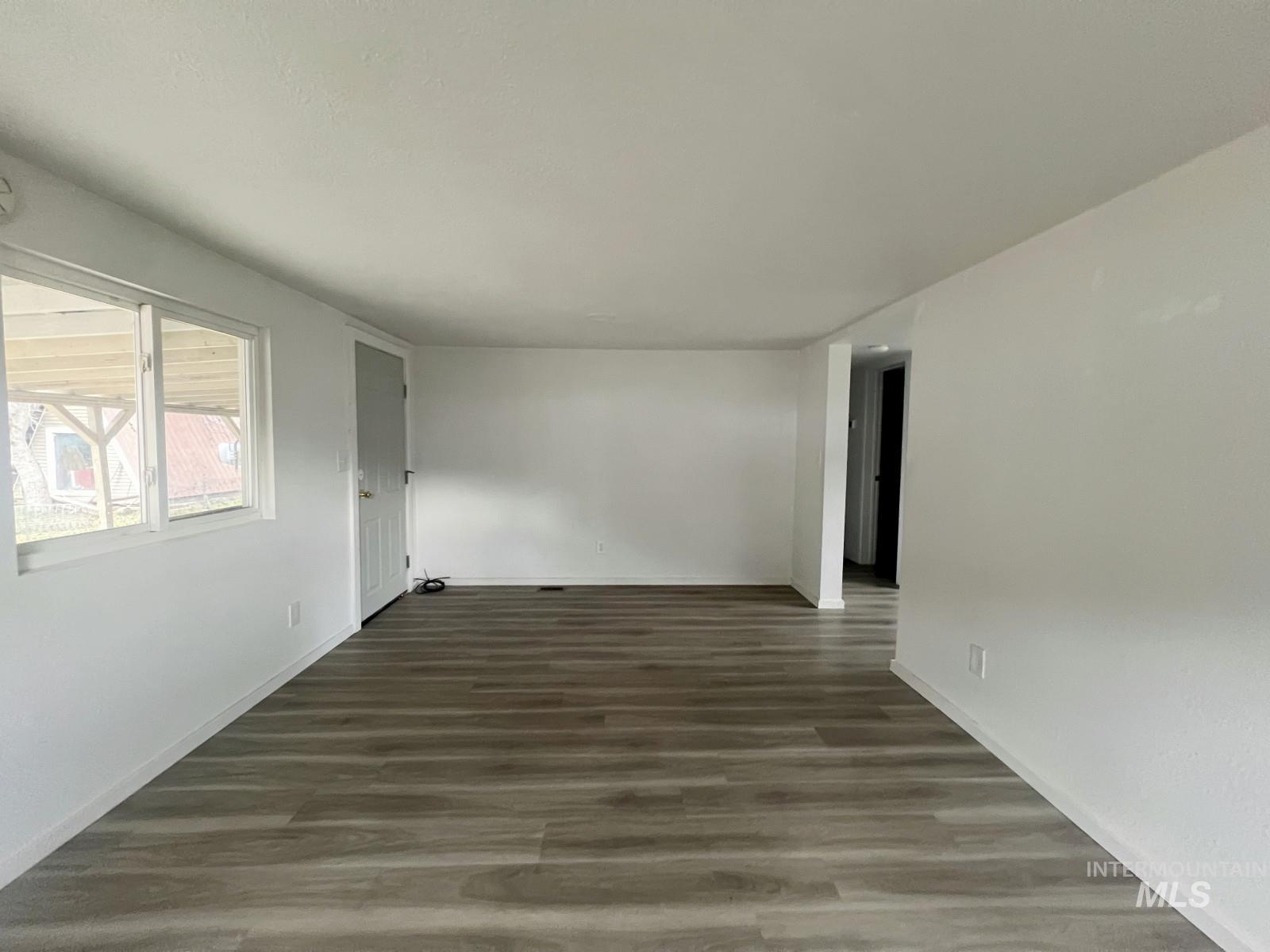 614 Pine Avenue Kooskia, ID 83539 - Photo 5 of 27 Empty room featuring dark wood-type flooring and baseboards
