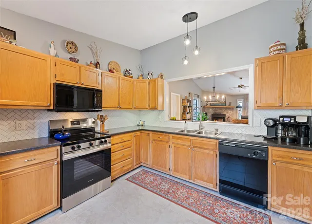 a kitchen with granite countertop stainless steel appliances and wooden cabinets