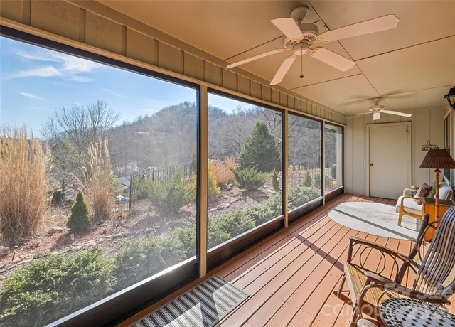 a view of a room with wooden floor and windows