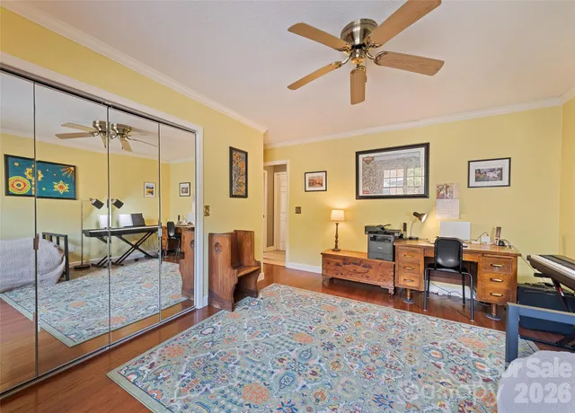 a living room with furniture a ceiling fan and a rug