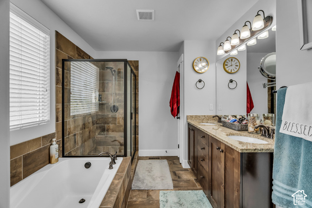 12992 West Geronimo Road Riverton, UT 84096 - Photo 11 of 25 Dual vanity with granite countertops, wood-finish cabinetry, and framed mirrors