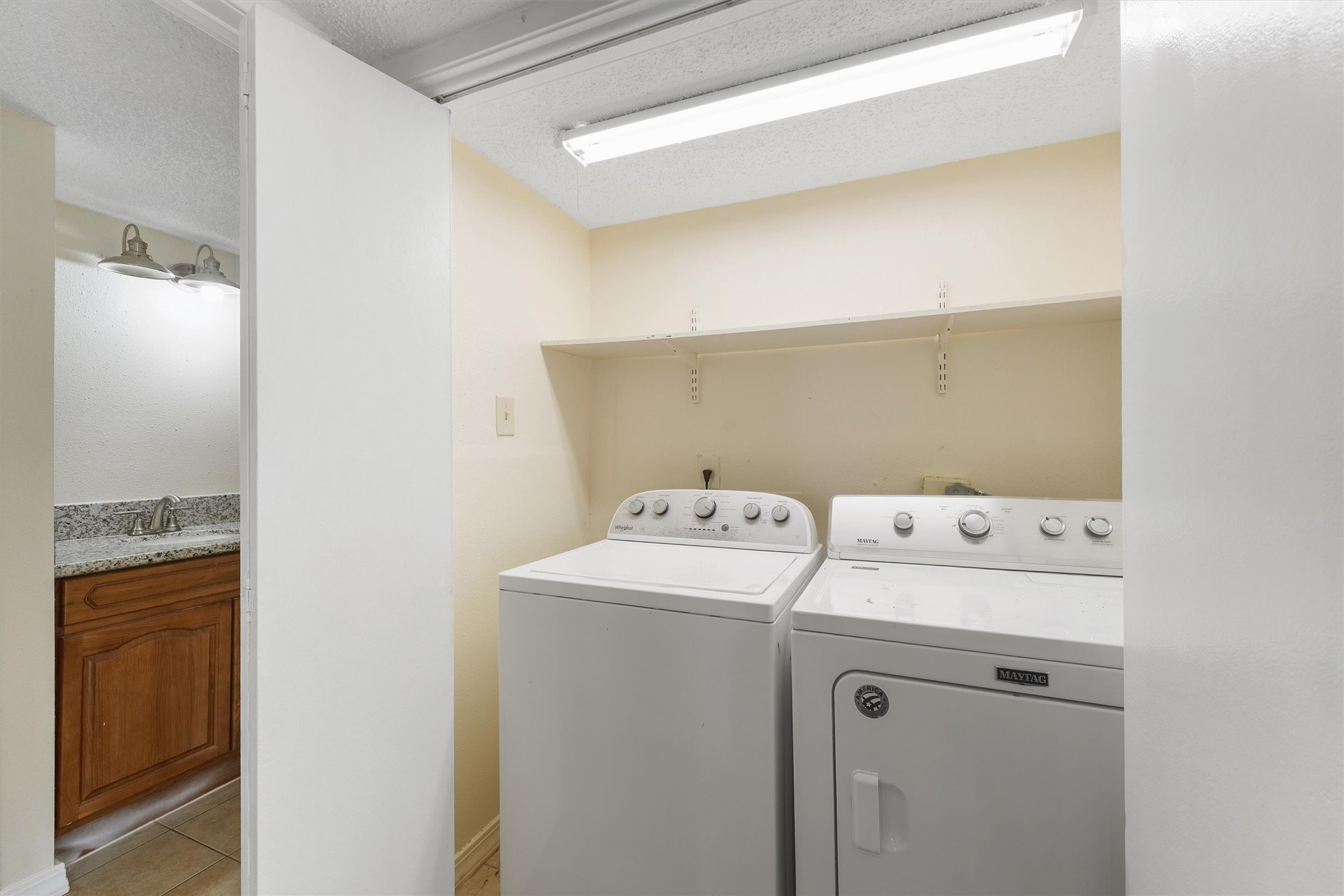 9221 Imogene Street, Unit 9221 Houston, TX 77036 - Photo 12 of 19 a utility room with dryer and washer