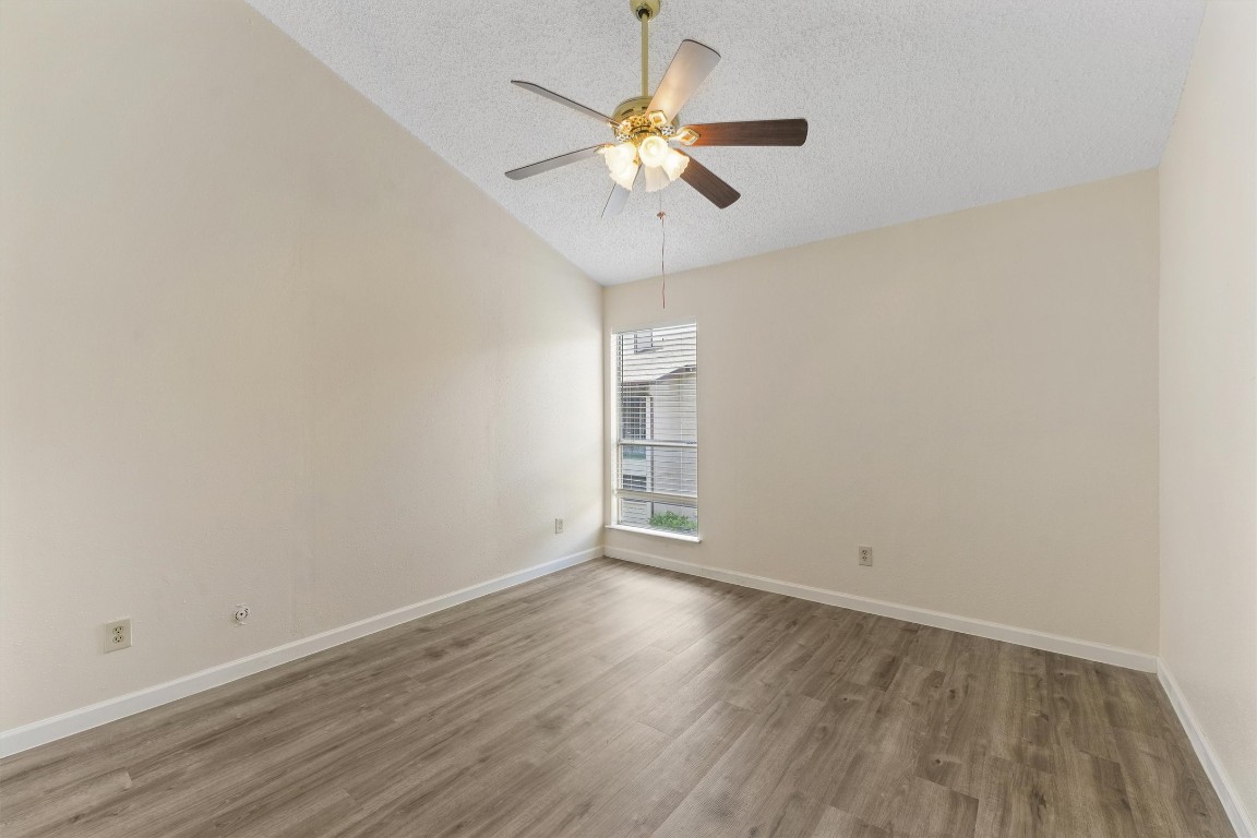 9221 Imogene Street, Unit 9221 Houston, TX 77036 - Photo 14 of 19 a view of an empty room with wooden floor