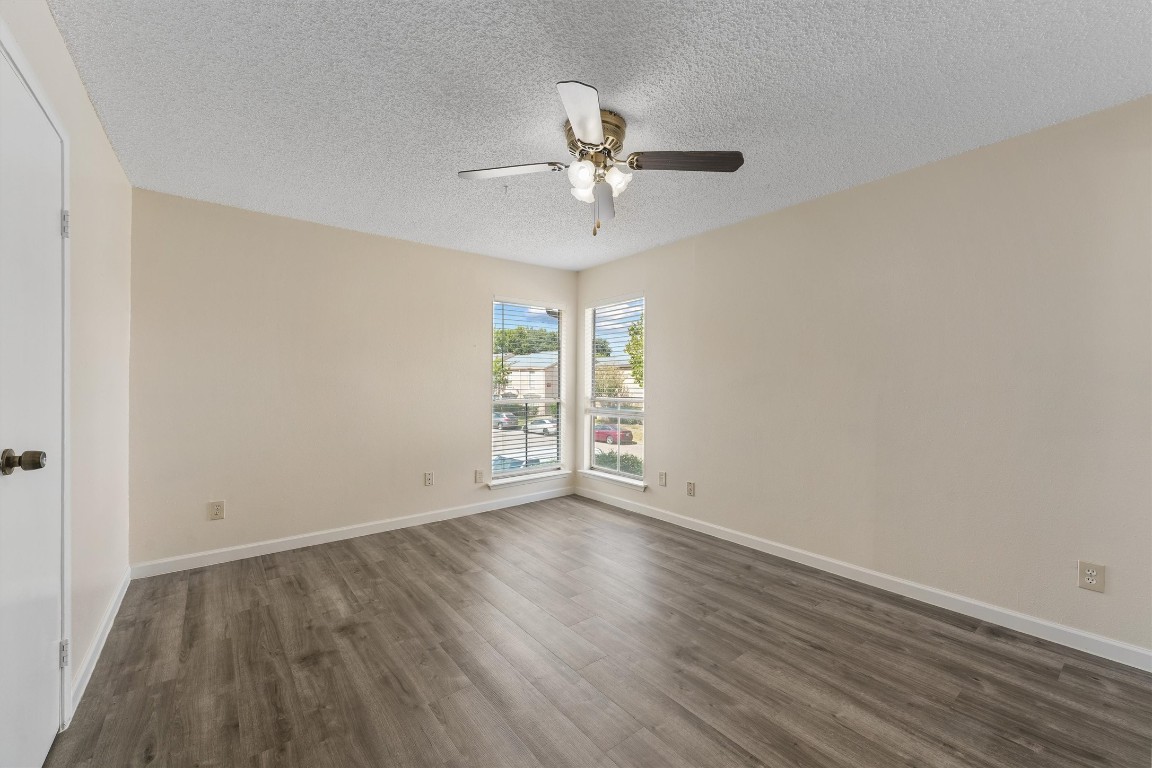 9221 Imogene Street, Unit 9221 Houston, TX 77036 - Photo 4 of 19 an empty room with wooden floor fan and windows