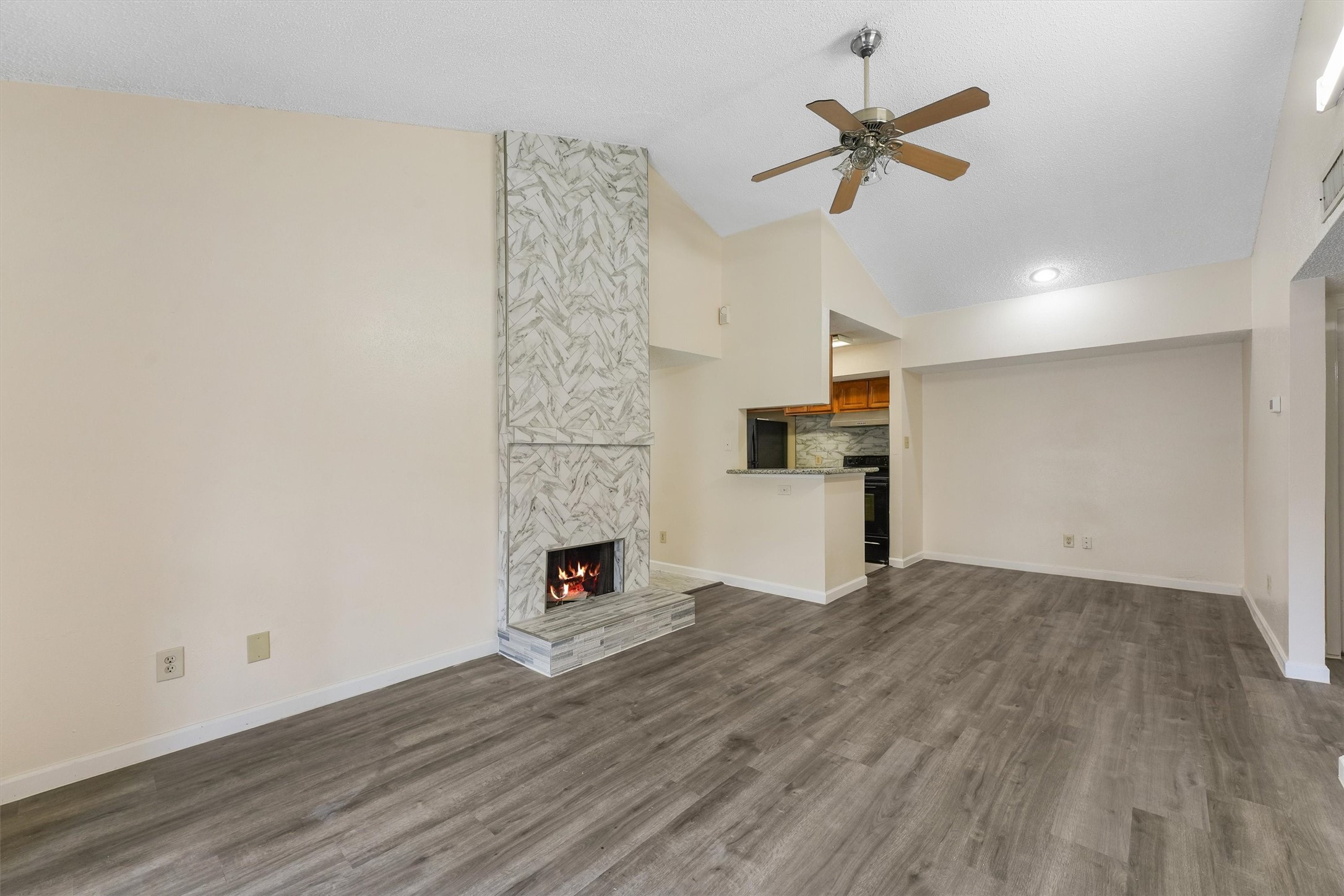 9221 Imogene Street, Unit 9221 Houston, TX 77036 - Photo 9 of 19 a view of empty room with wooden floor and ceiling fan
