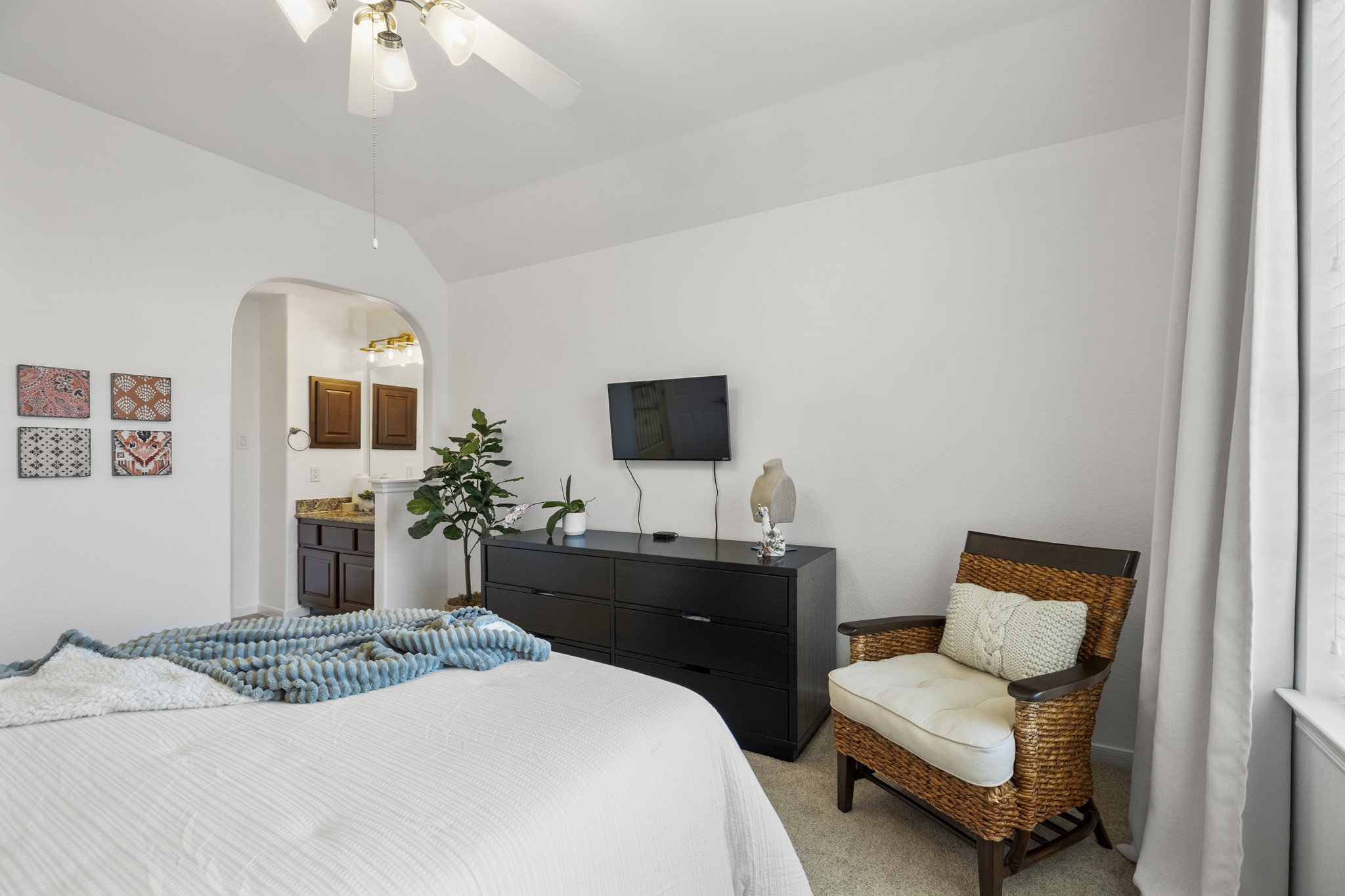 26 Winhall Place The Woodlands, TX 77354 - Photo 33 of 49 a bedroom with a bed and a chandelier