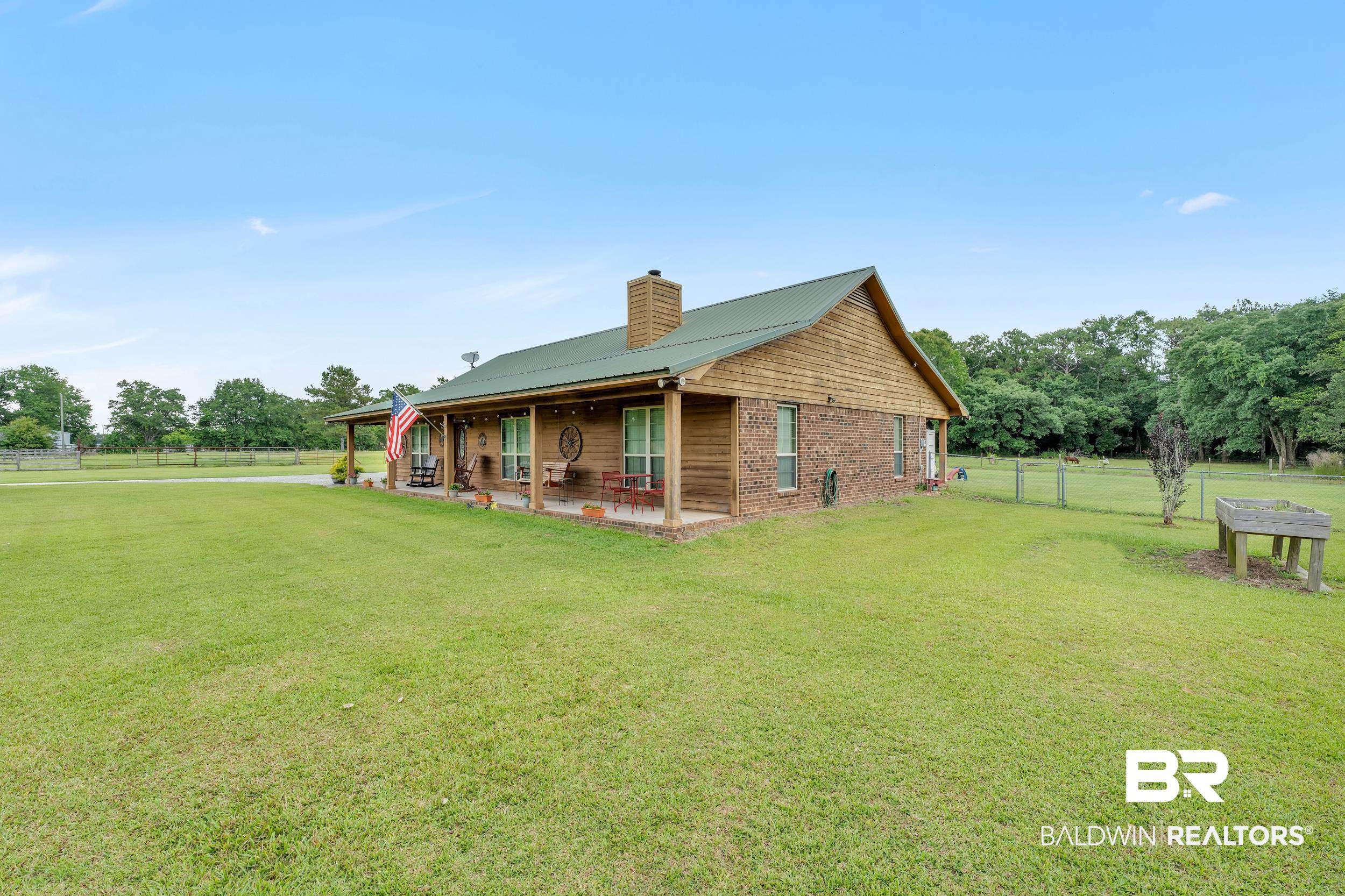 4062 River Road Theodore, AL 36582 - Photo 6 of 32 Rear view of house with a chimney, a patio, and metal roof