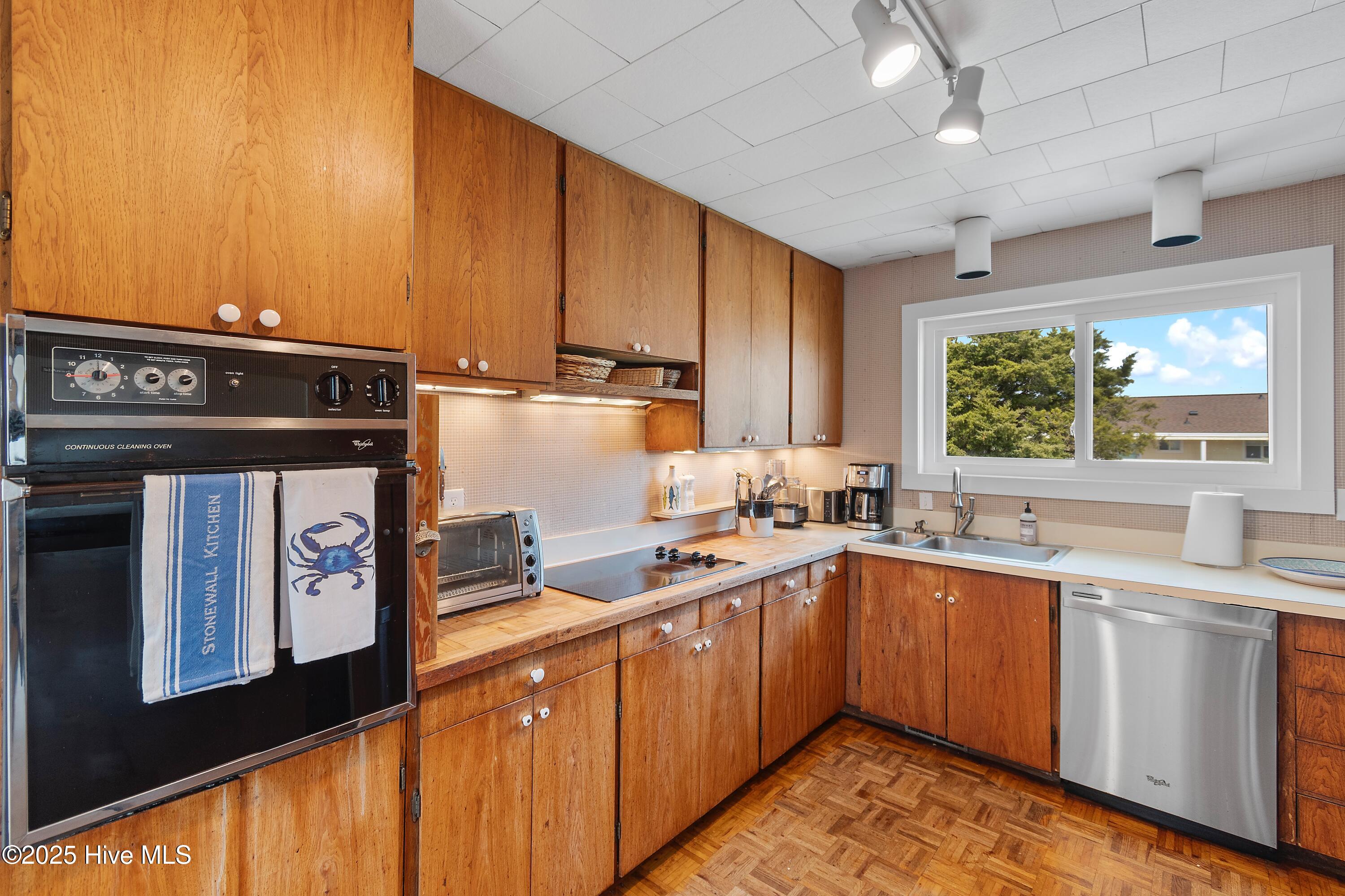 402 Dolphin Street Sunset Beach, NC 28468 - Photo 23 of 53 Kitchen with wall over & cooktop