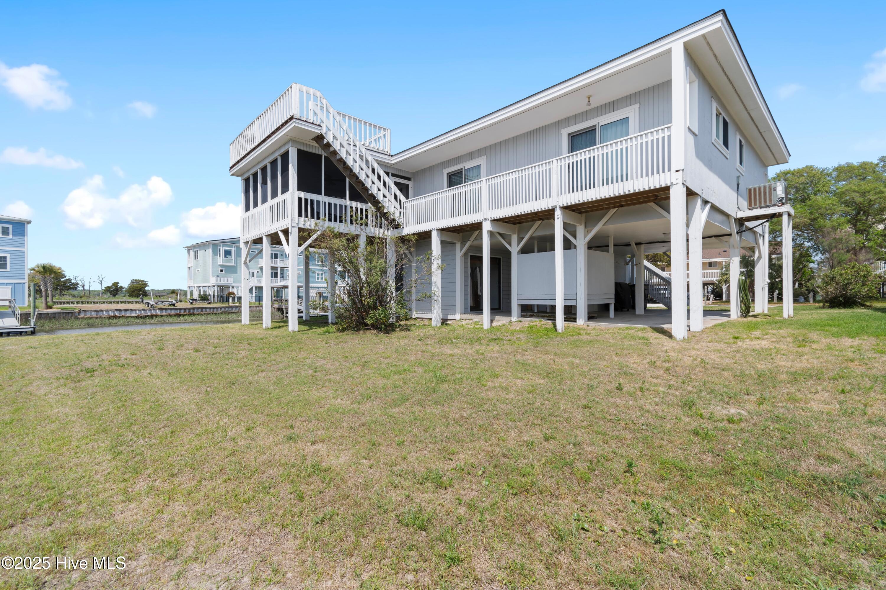 402 Dolphin Street Sunset Beach, NC 28468 - Photo 9 of 53 Nice Waterfront Yard for Fun