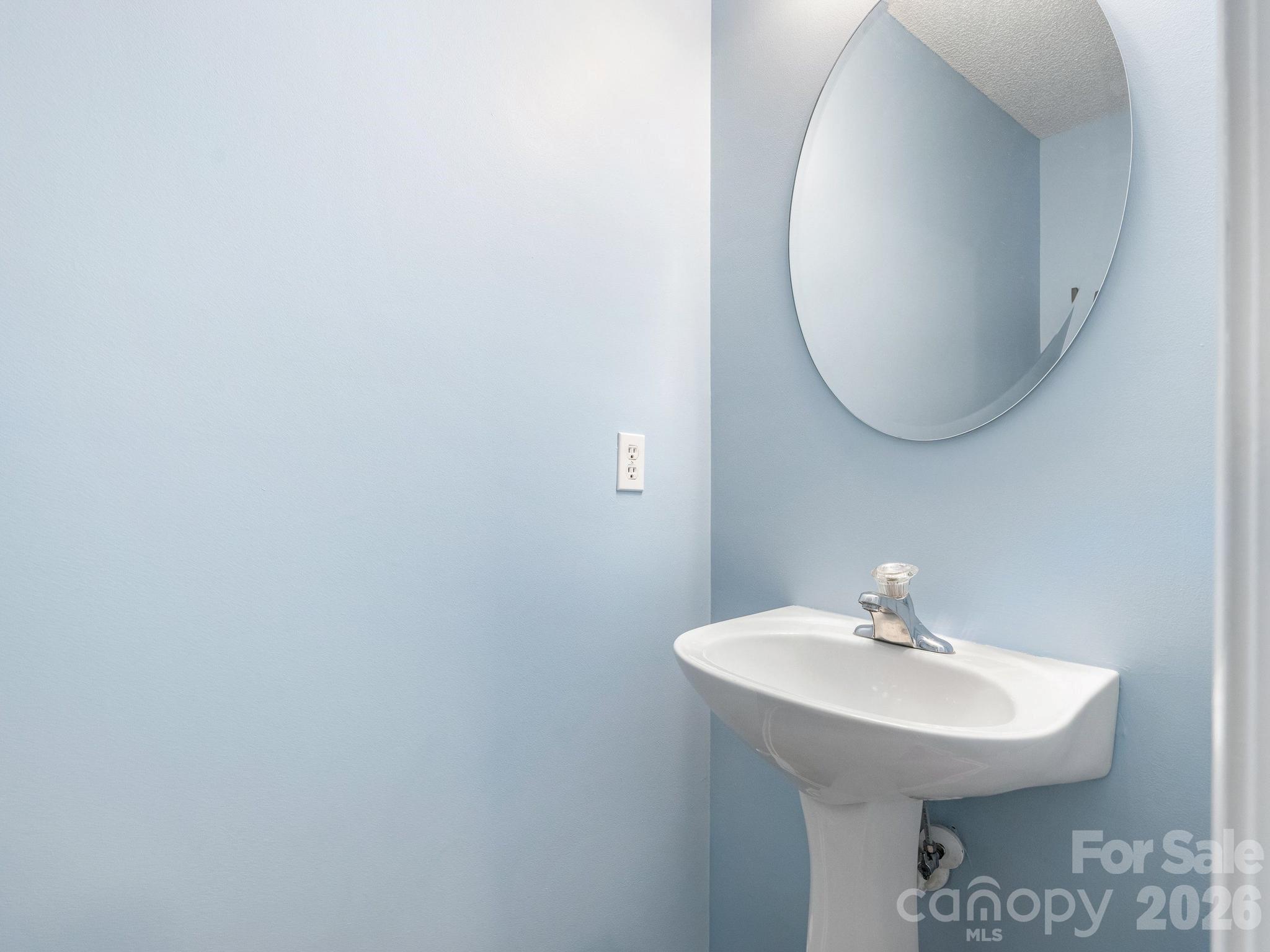 3259 Blythe Ridge Court Charlotte, NC 28213 - Photo 7 of 17 a bathroom with a sink a mirror and a toilet