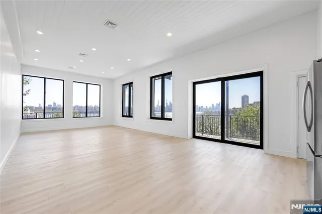 a view of an empty room with glass door