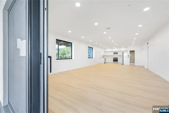 a view of a hallway with a bedroom and kitchen view