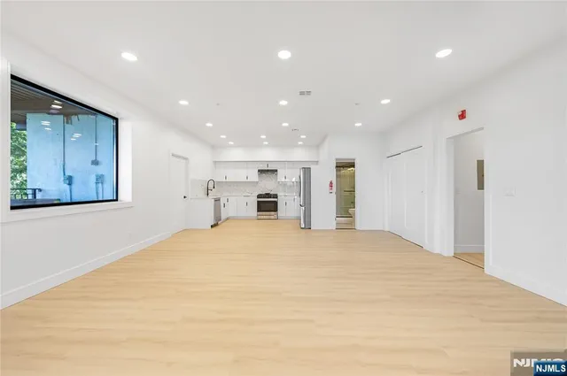 a big room with closet and a large window