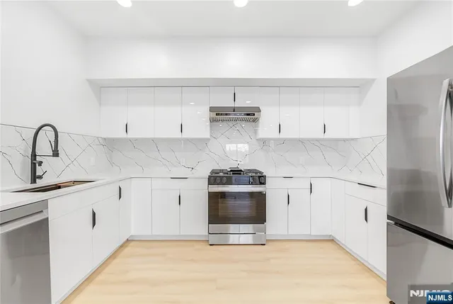 a kitchen with a stove and a refrigerator