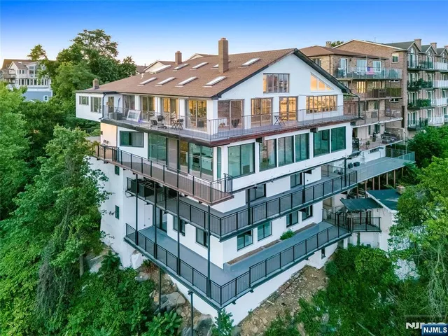 a view of a big building with a big yard and large trees