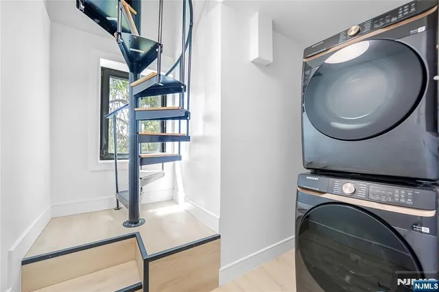 a view of a livingroom with wooden floor and a staircase