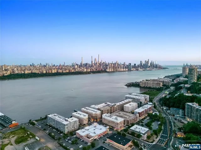 a view of a lake with houses in the back