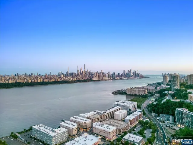 a view of a lake with couches and city view