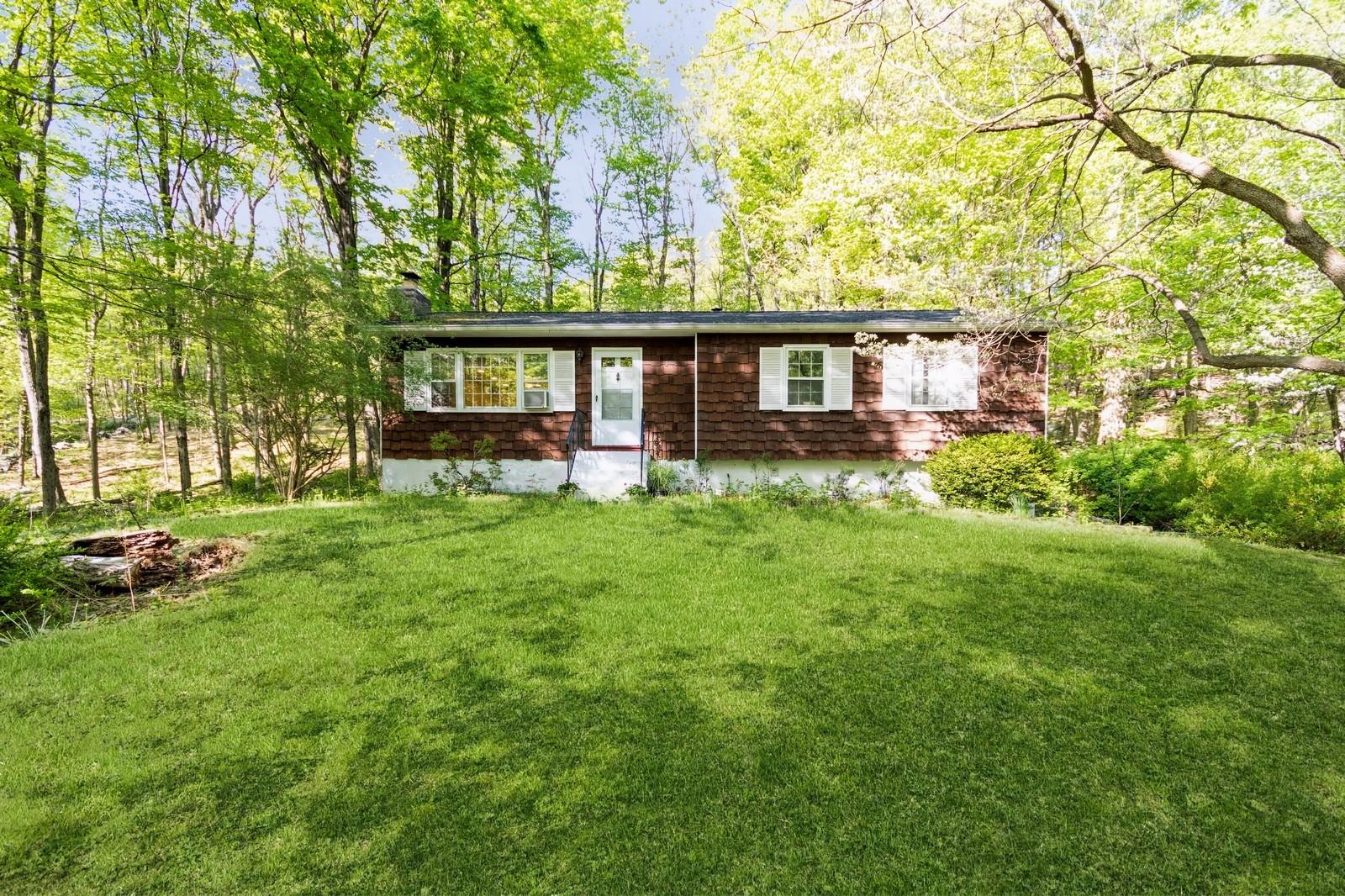 125 Barrett Pond Road Cold Spring, NY 10516 - Photo 1 of 1 a front view of house with yard and green space
