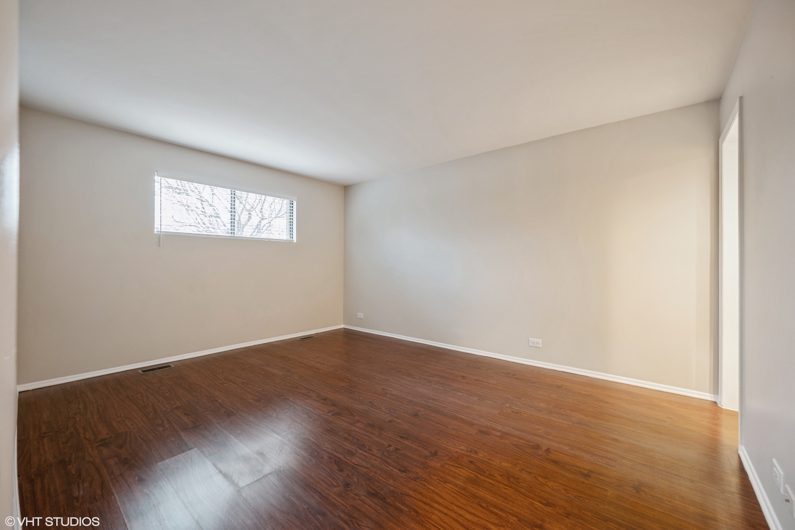 Undisclosed Address Northfield, IL 60093 - Photo 8 of 10 a view of an empty room with wooden floor and a window
