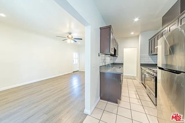 a view of a kitchen with refrigerator and an oven