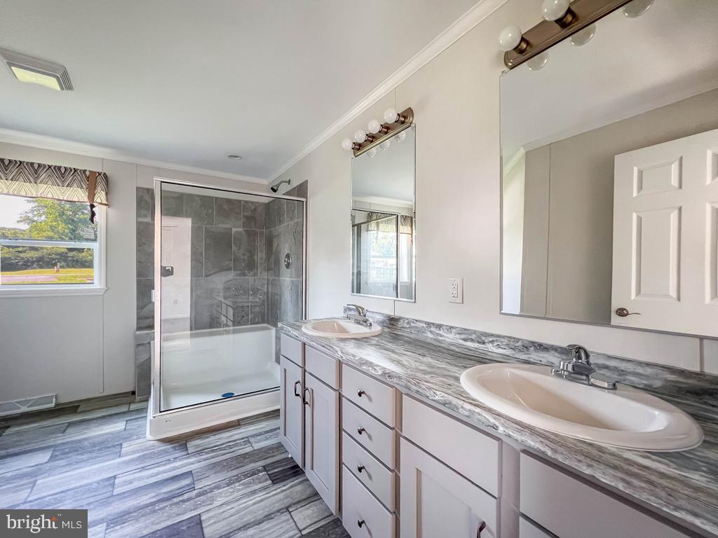 141 Minch Road Parkesburg, PA 19365 - Photo 27 of 34 a bathroom with a granite countertop sink mirror and shower