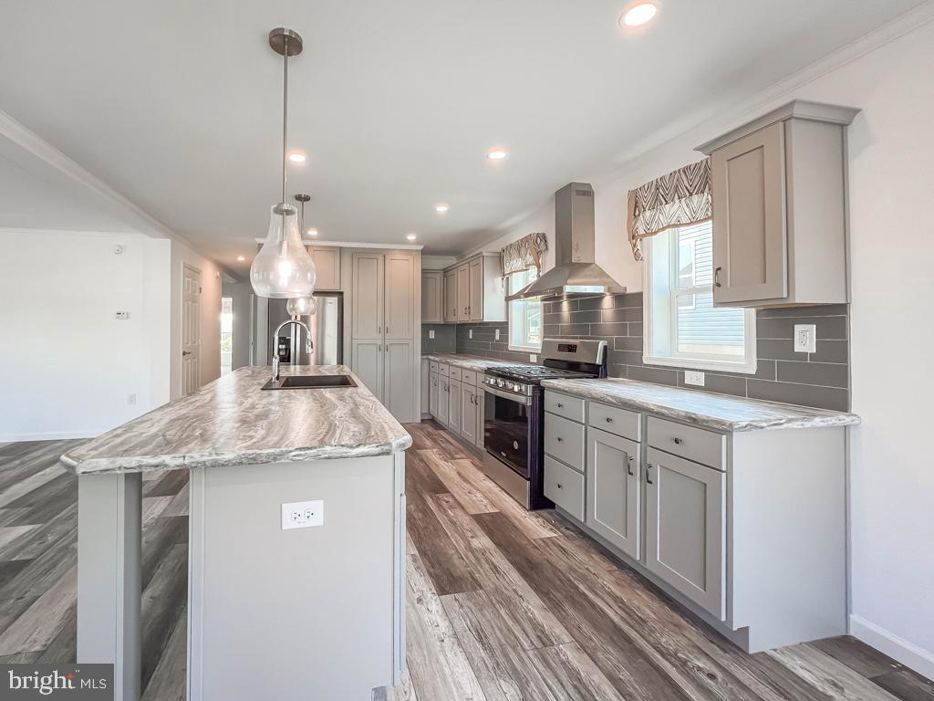 141 Minch Road Parkesburg, PA 19365 - Photo 5 of 34 a kitchen with stainless steel appliances granite countertop a sink a stove and a refrigerator