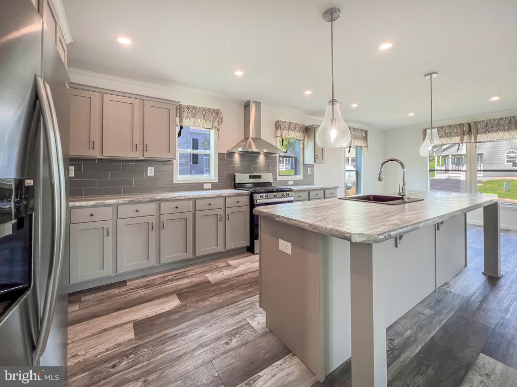 141 Minch Road Parkesburg, PA 19365 - Photo 9 of 34 a kitchen with stainless steel appliances granite countertop a sink a stove and a refrigerator