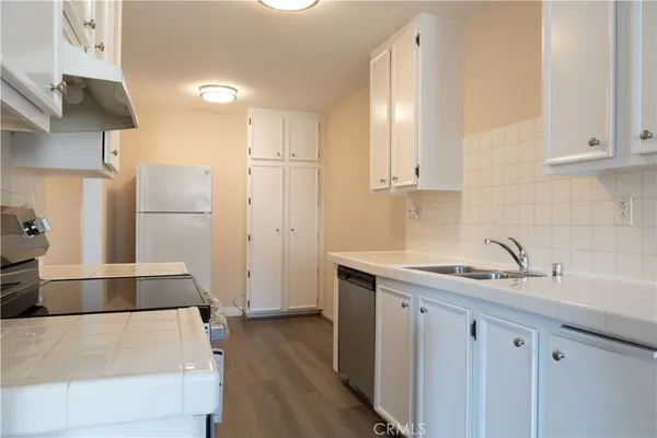 a kitchen with a sink and a refrigerator