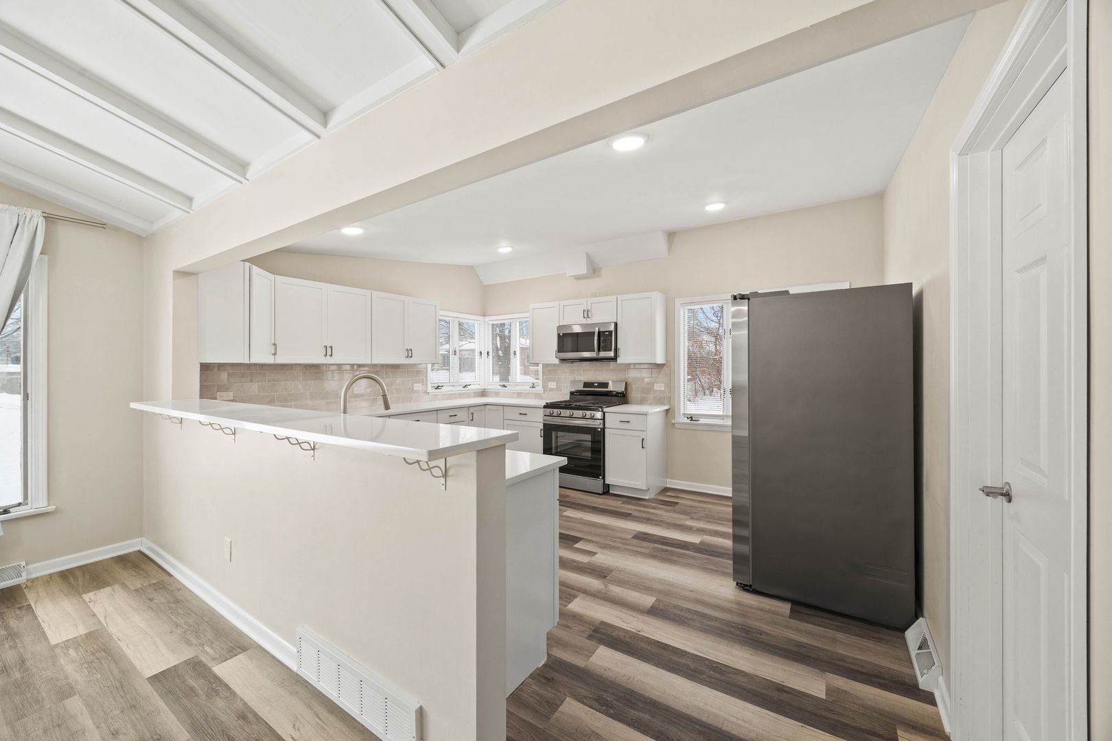 246 Miller Avenue DeKalb, IL 60115 - Photo 11 of 36 a kitchen with white cabinets and refrigerator