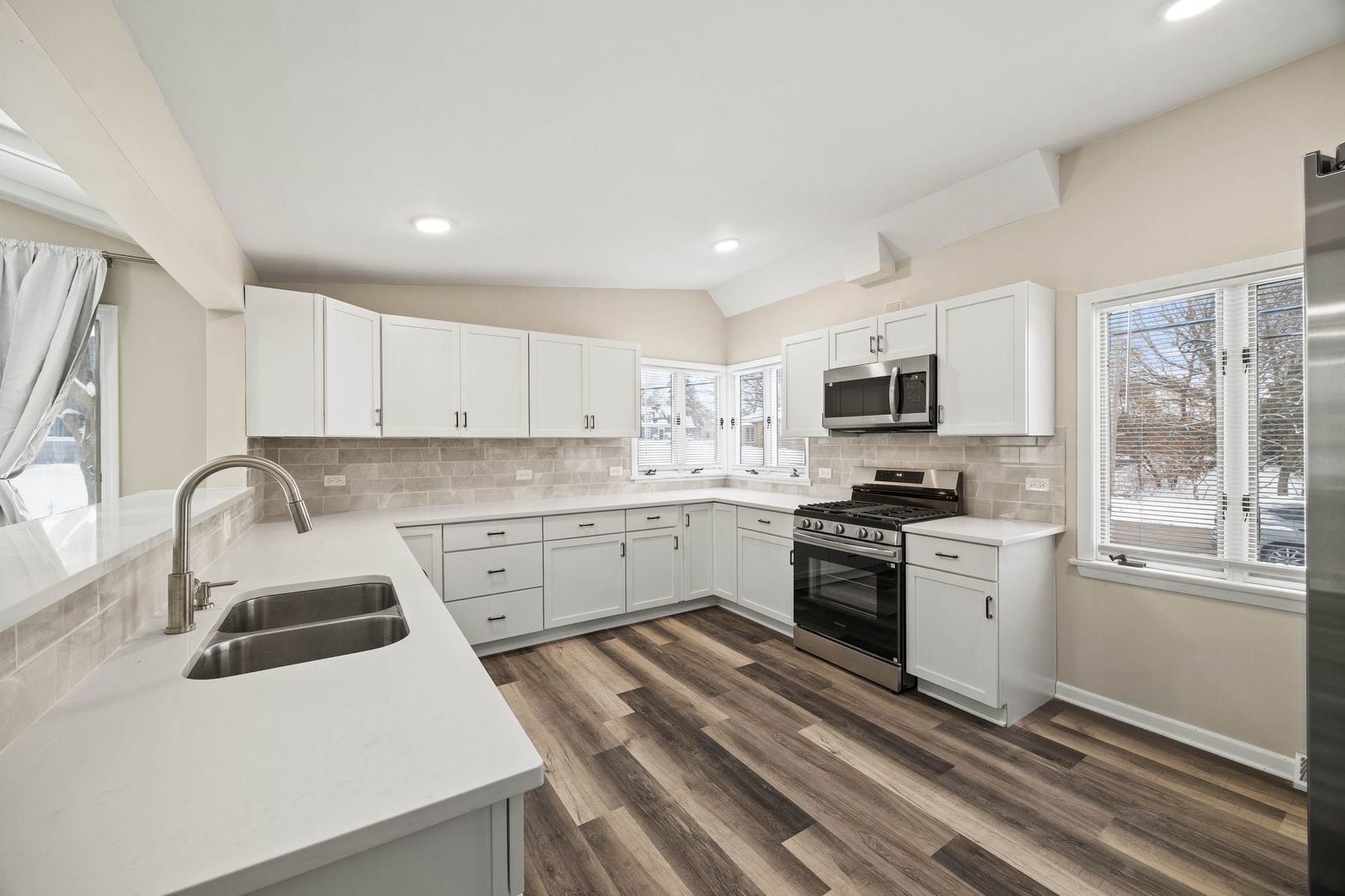 246 Miller Avenue DeKalb, IL 60115 - Photo 12 of 36 a kitchen with granite countertop white cabinets and white appliances
