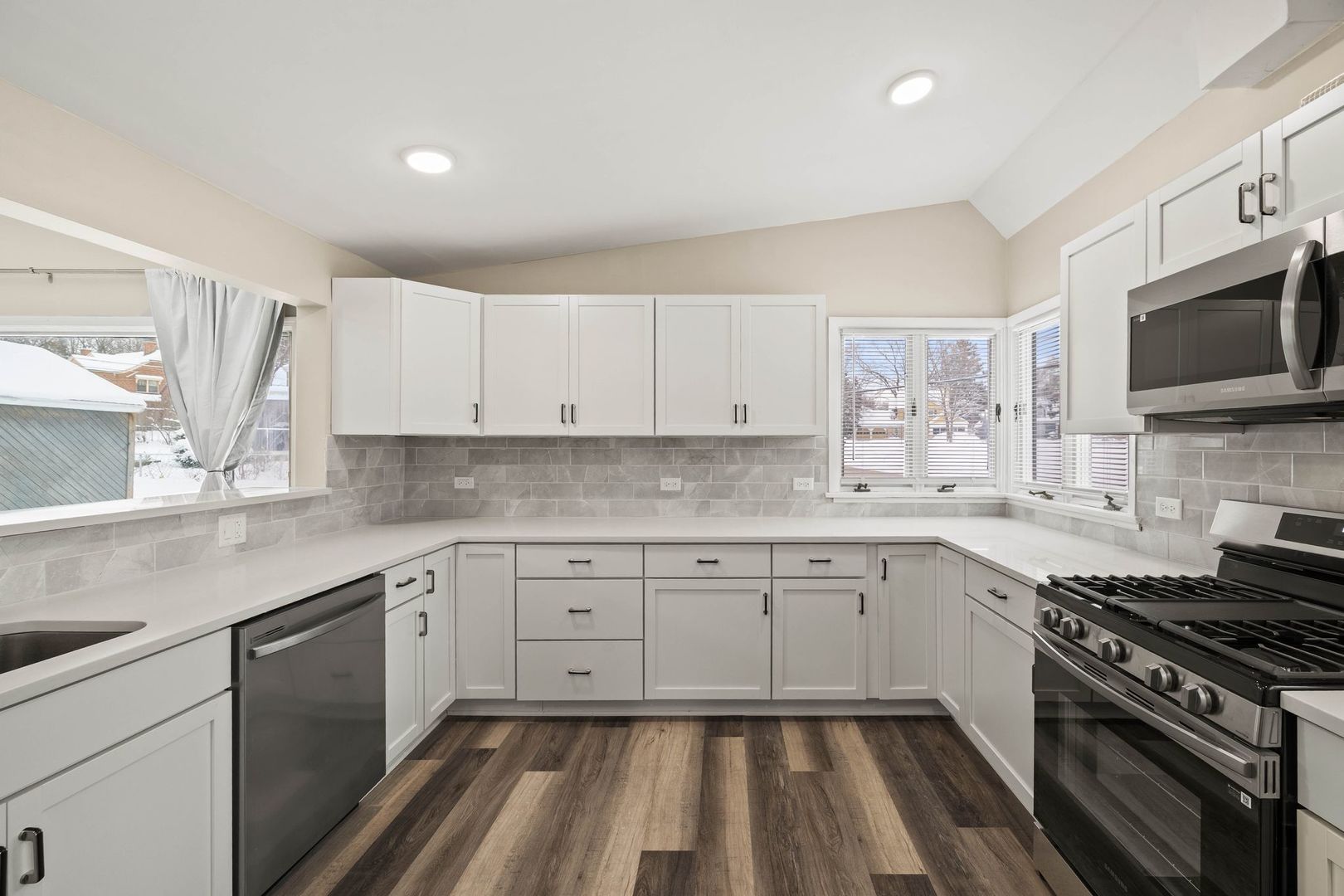246 Miller Avenue DeKalb, IL 60115 - Photo 13 of 36 a kitchen with granite countertop white cabinets and appliances