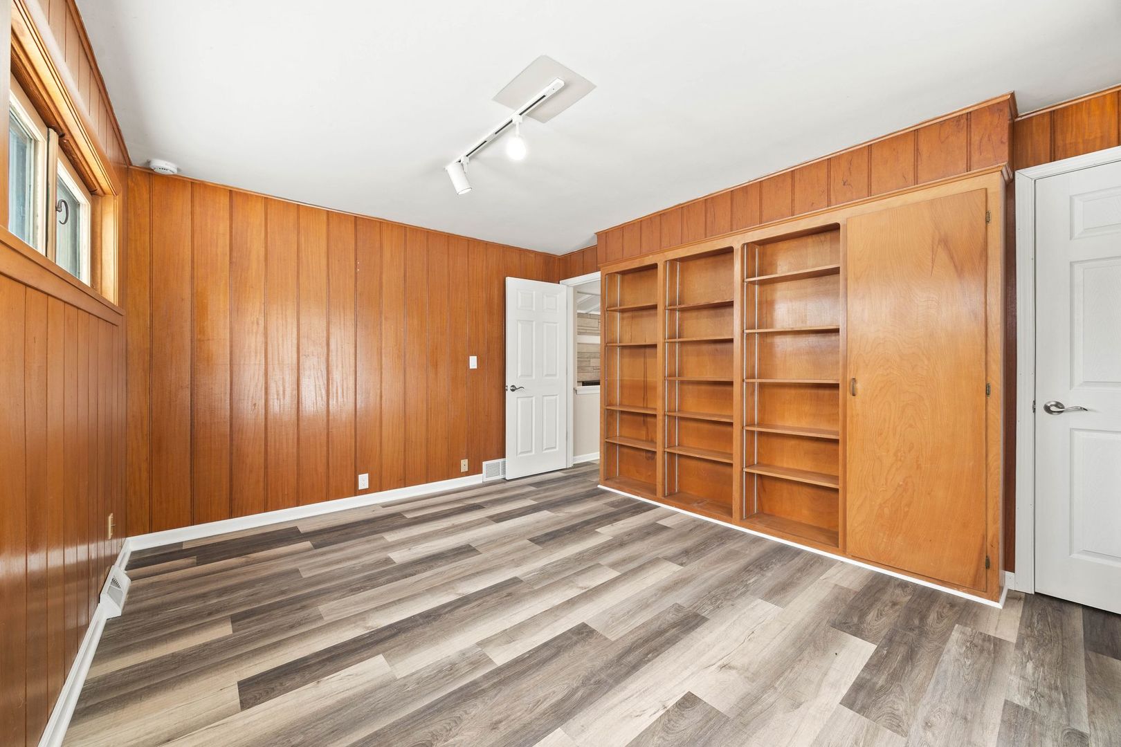 246 Miller Avenue DeKalb, IL 60115 - Photo 16 of 36 a view of an empty room with wooden floor and a window