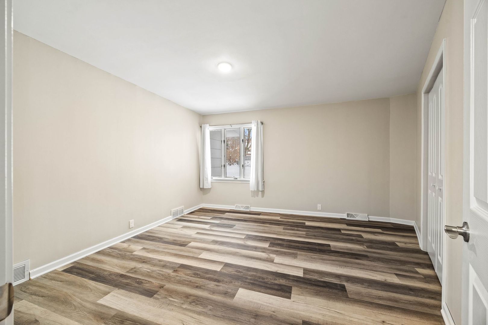 246 Miller Avenue DeKalb, IL 60115 - Photo 21 of 36 a view of a room with wooden floor and window