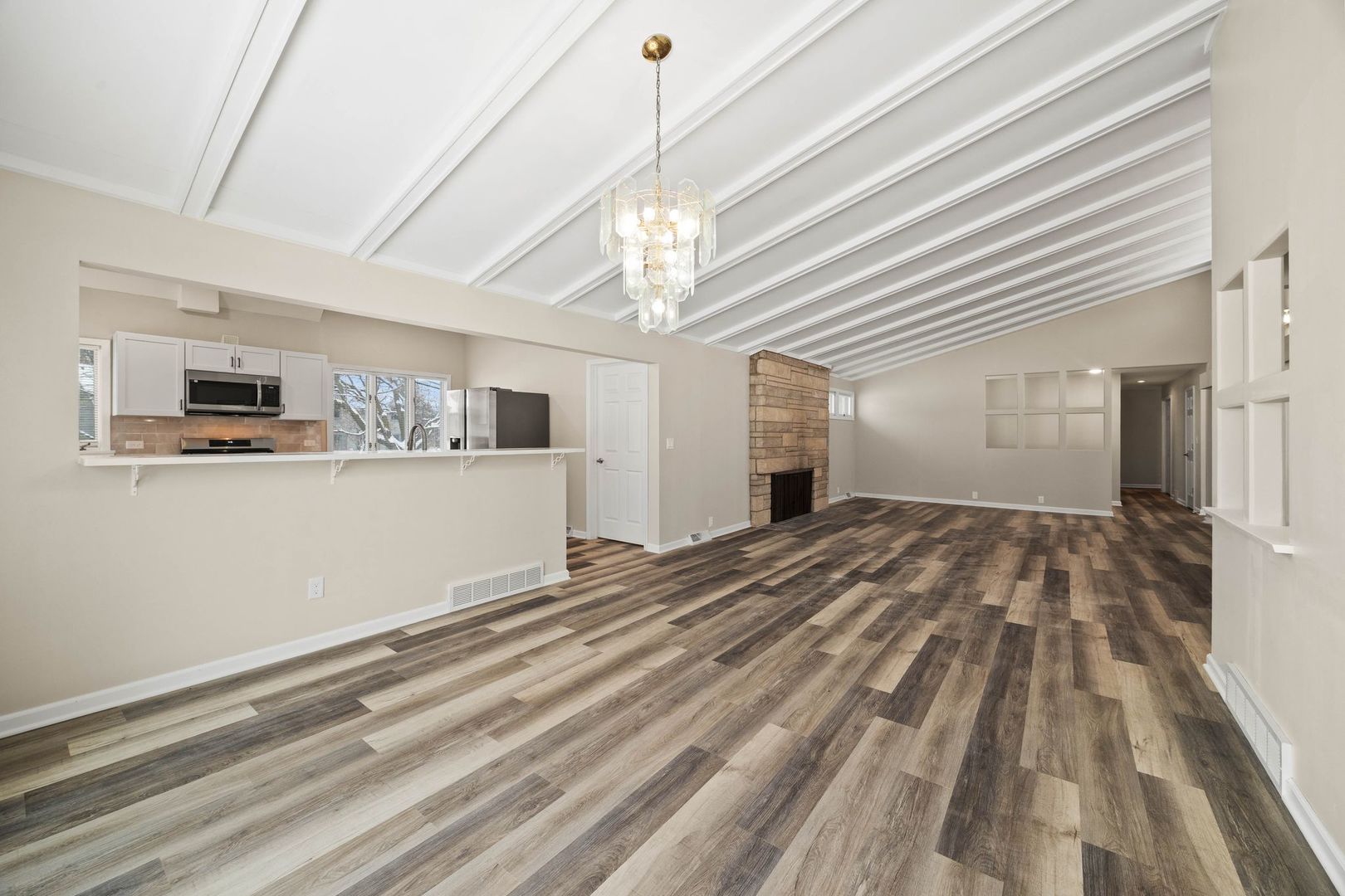 246 Miller Avenue DeKalb, IL 60115 - Photo 6 of 36 a view of a livingroom with wooden floor and kitchen space