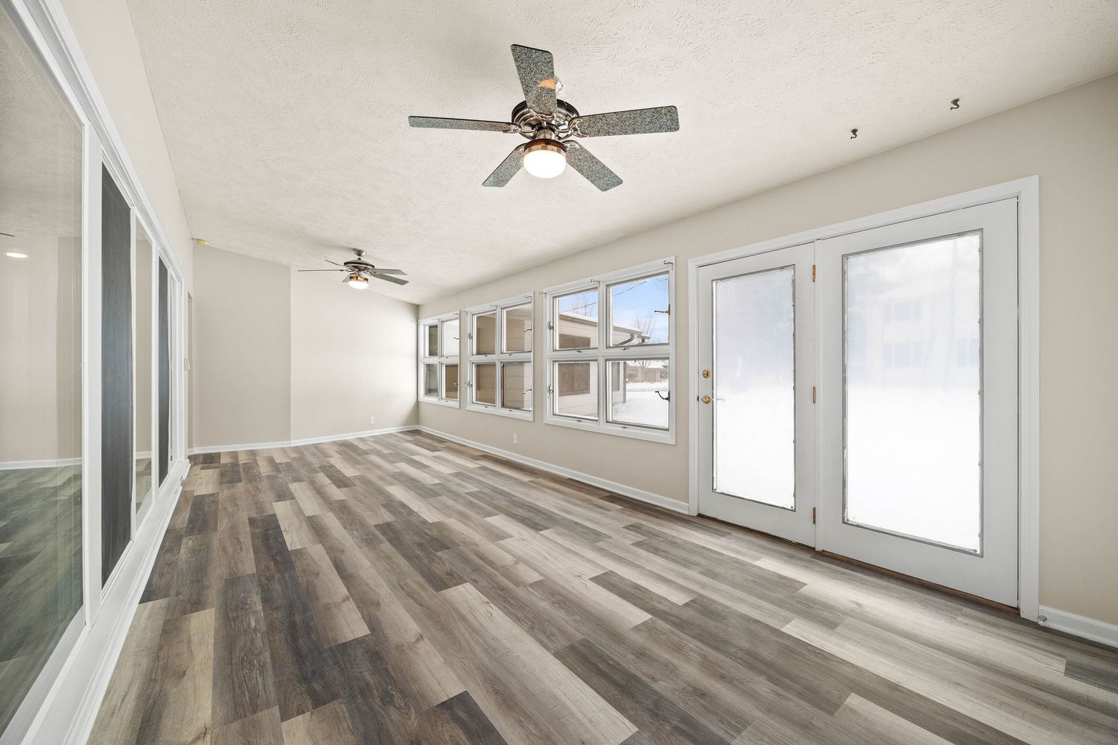 246 Miller Avenue DeKalb, IL 60115 - Photo 8 of 36 a view of empty room with wooden floor and fan